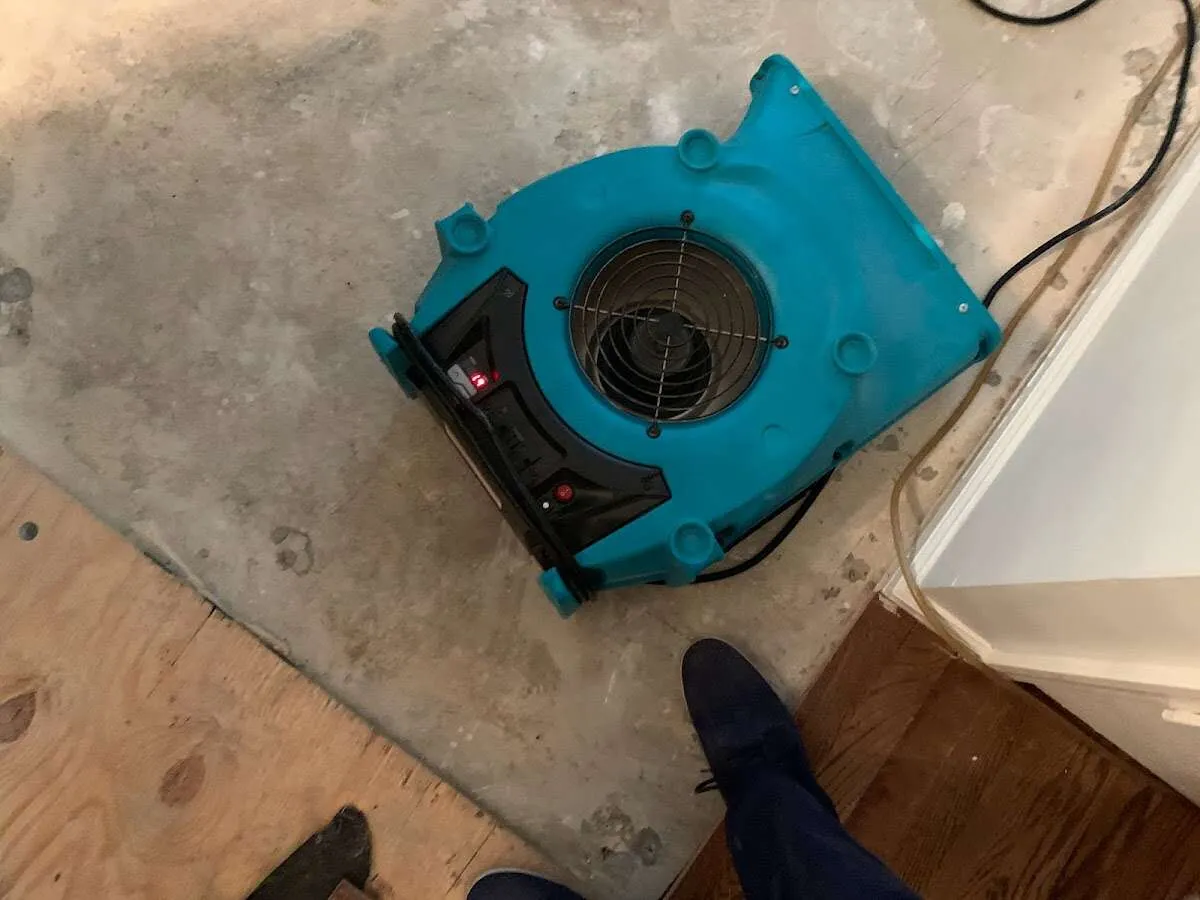 Air mover drying subfloor during Leak Detection & Repair in Gateway
